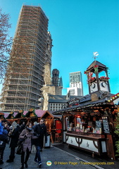 Modern Belfry of the Kaiser Wilheim Memorial Church  towering over the Christmas market